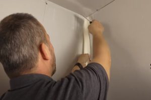 Salem Drywall Repair worker taping the corner of the wall